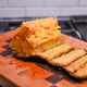 Cooked pineapple, caramelized with skin sliced off on cutting board